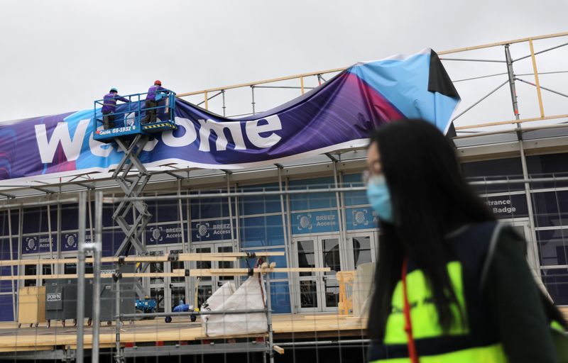 Employee walks past a banner of MWC20 in Barcelona