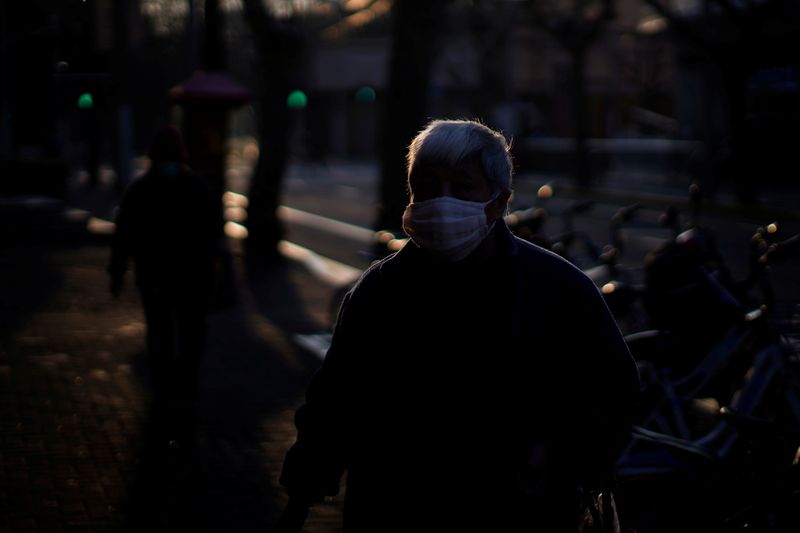 A man wearing a mask is seen in downtown Shanghai