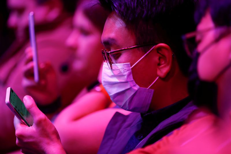 FILE PHOTO: An attendee wears a surgical mask during Samsung Galaxy Unpacked 2020 in San