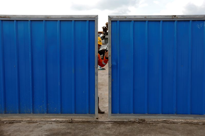 FILE PHOTO: A worker closes the gate at Walini tunnel construction site for Jakarta-Bandung