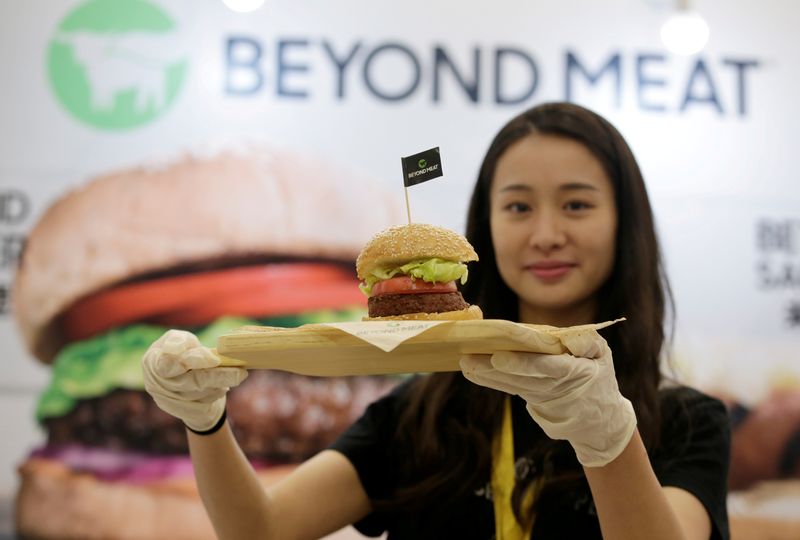 FILE PHOTO: Staff member displays a burger with a Beyond Meat plant-based patty at VeggieWorld
