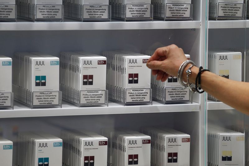 A customer shops for catridges of Juul vaping brand at a Juul shop in Jakarta