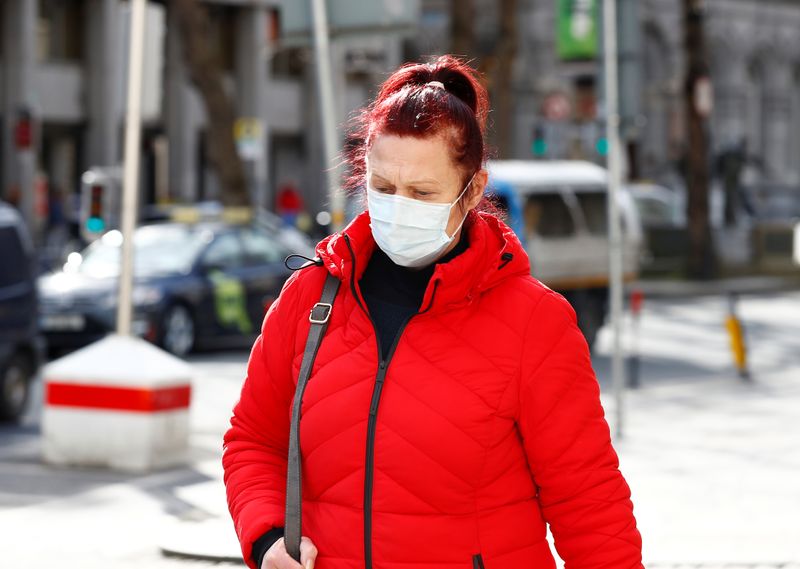 A woman wearing a face mask on St. Patrick's Day as public events were cancelled due to the
