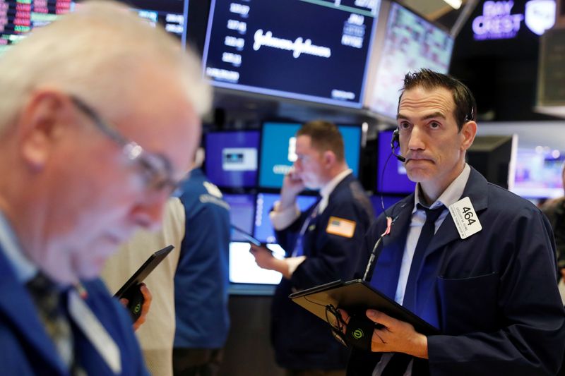 Traders work on the floor of the New York Stock Exchange shortly after the opening bell as