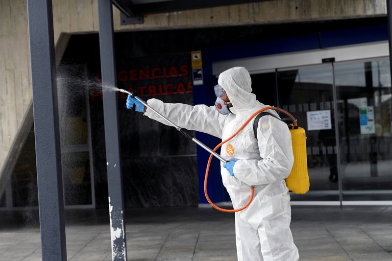 A member of the Military Emergency Unit (UME) disinfects the HUCA (Central University Hospital