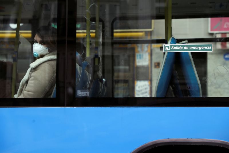 A woman wears a protective face mask at a local market during partial lockdown as part of a