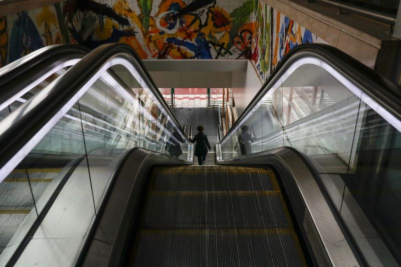 A lone passenger walks down the escalator at Chamartin train station during the partial