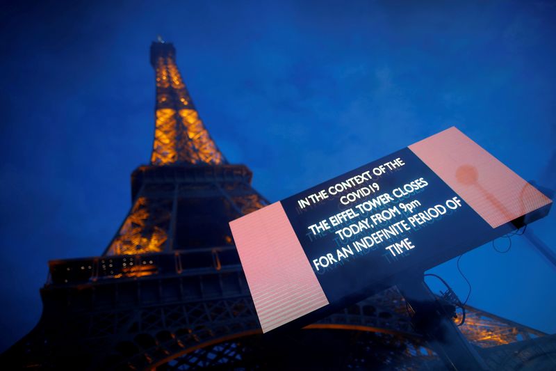 FILE PHOTO: The Eiffel Tower is seen next to a board that reads: 