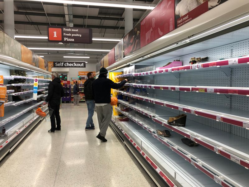 Empty shelves are seen at a Sainsbury's store in south London as the numbers of coronavirus