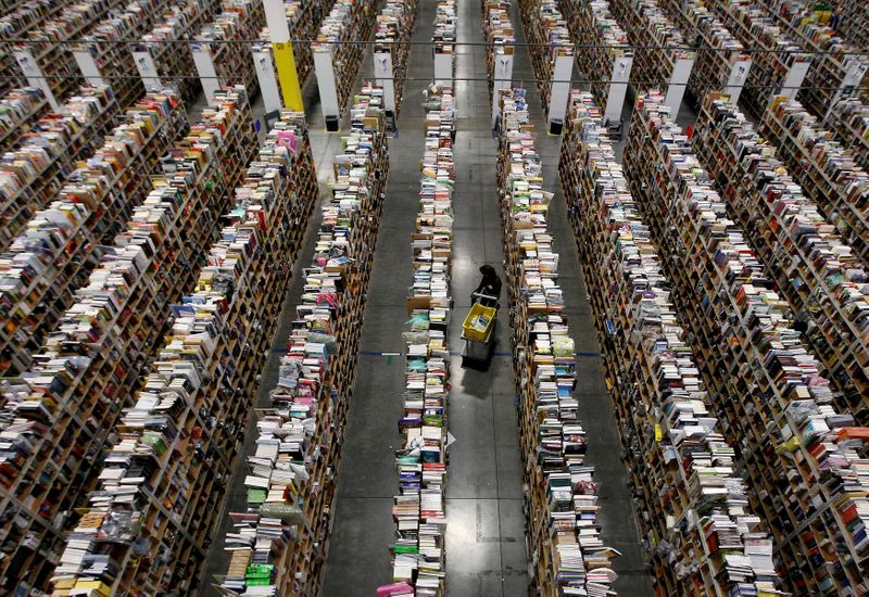 FILE PHOTO: FILE PHOTO: Worker gathers items for delivery at Amazon's distribution center in