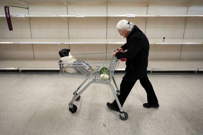 People are seen at the fruit and vegetable aisle in Sainsbury's supermarket