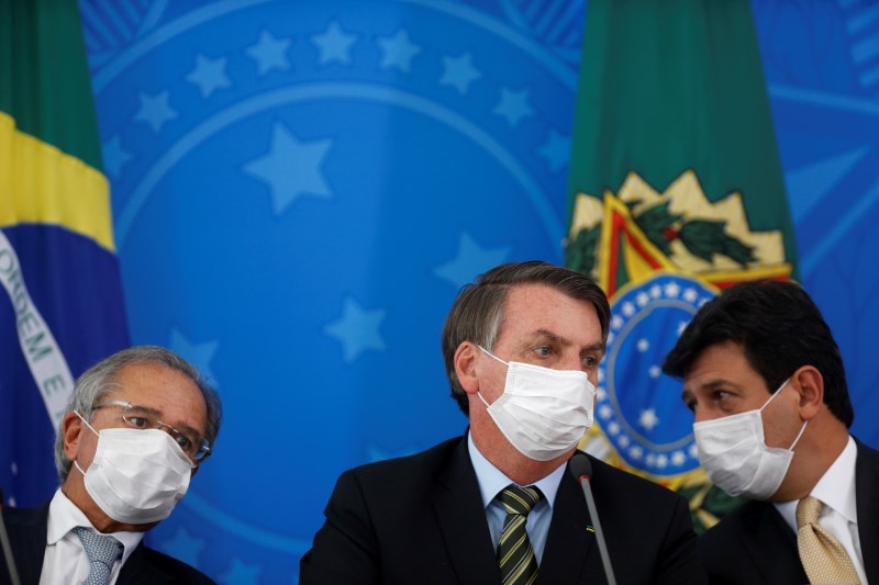 Brazil's President Bolsonaro, Minister of Health Mandetta and Economy Minister Guedes attend a