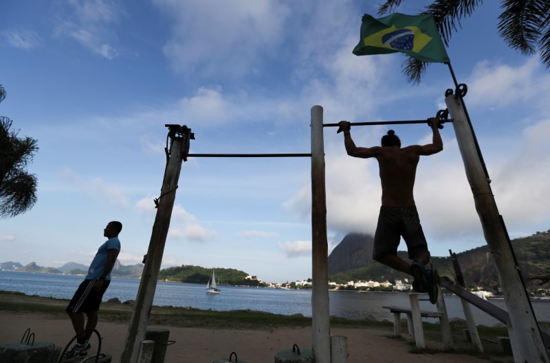 A man exercises in front of the Guanabara Bay after authorities announced measures due to the