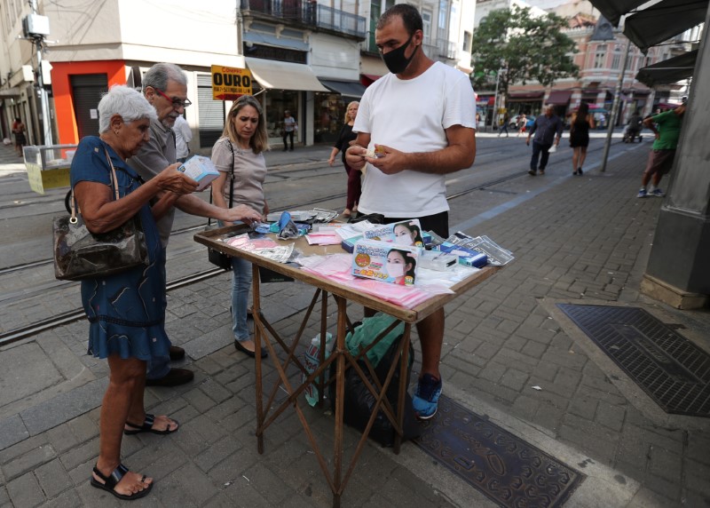 A street vendor sells protective masks after authorities announced measures to curb the spread