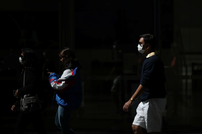 Pedestrians wear protective face masks amidst fears of the coronavirus disease (COVID-19) in