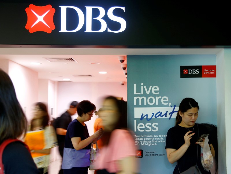 People walk past a DBS branch in Singapore