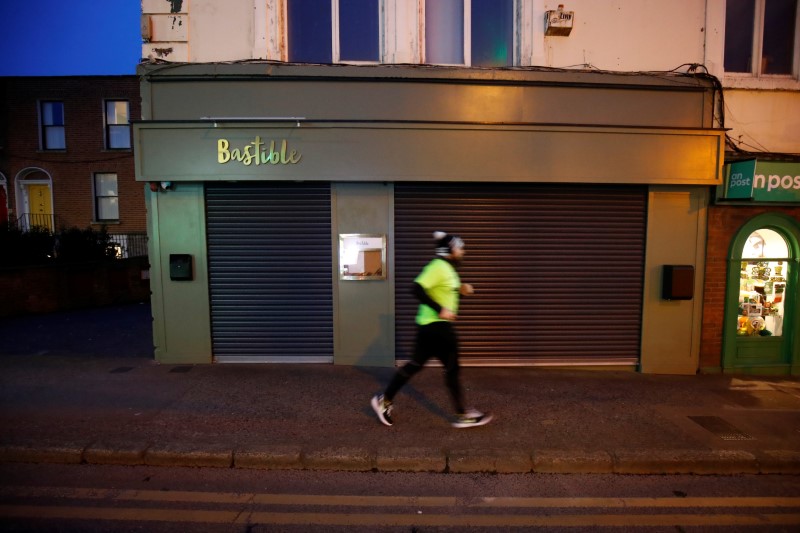 A runner jogs past the shuttered Bastible restaurant, after it closed its doors on Sunday amid
