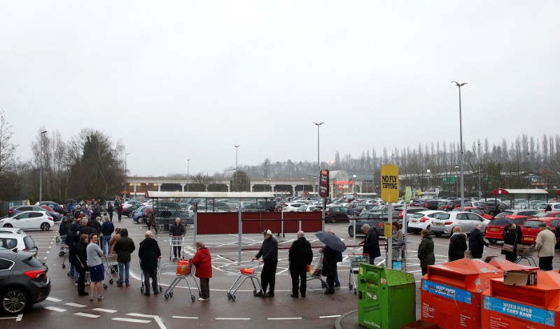 People queue outside of a Waitrose supermarket in St Albans