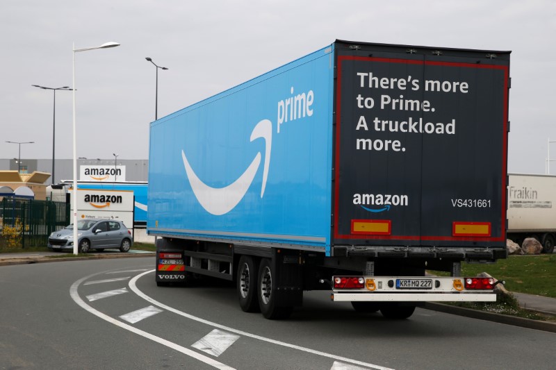 A truck with the logo of Amazon Prime Delivery arrives at the Amazon logistics center in