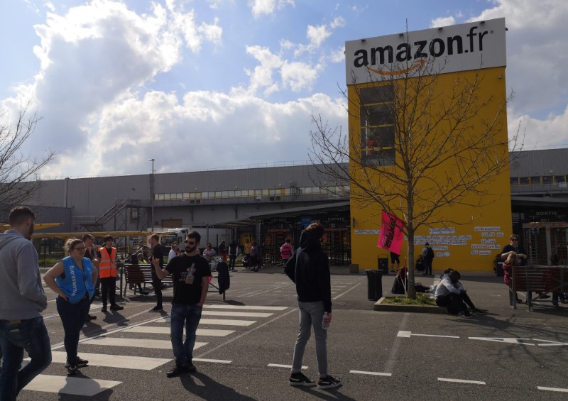 Amazon employees on strike gather outside the Amazon logistics center in Lauwin-Planque