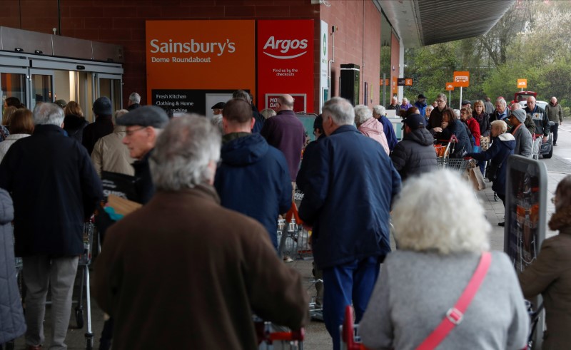 People queue outside a supermarket during the spread of coronavirus disease (COVID-19) in