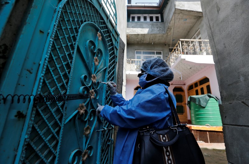 A guard outside the Royal Palace wears a protective mask as precaution against the coronavirus