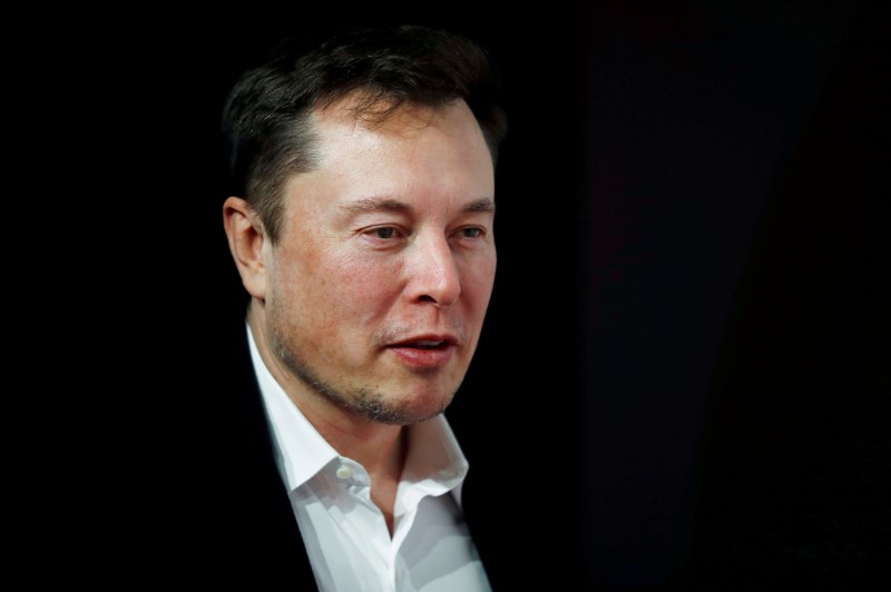 An employee of a Tesla Inc's U.S. vehicle factory is seen at a security gate in Fremont,