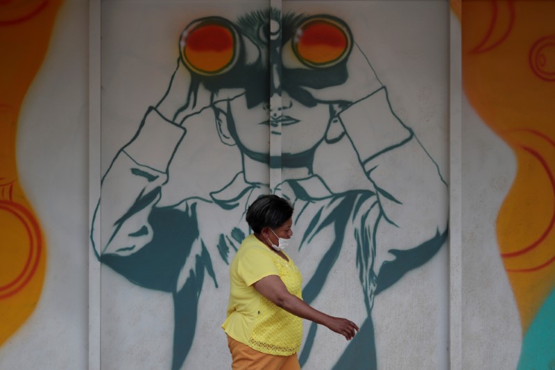 A woman walks as she wears a protective mask during the coronavirus disease (COVID-19) outbreak