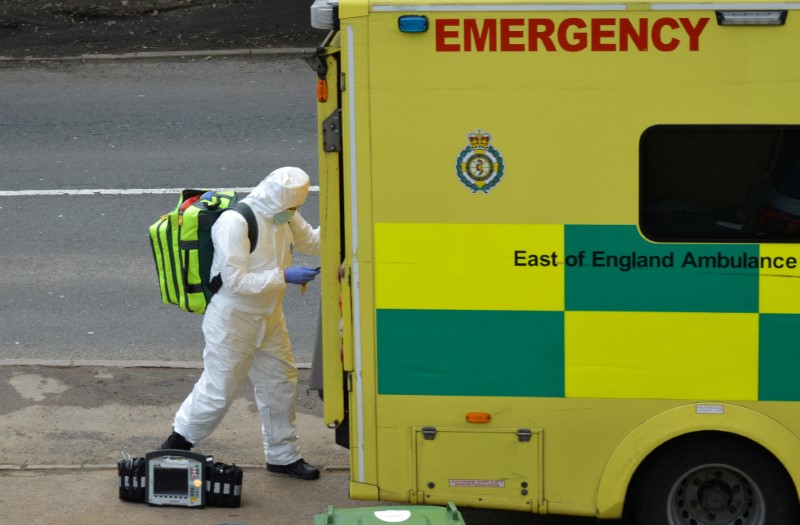 FILE PHOTO: A paramedic is seen in Cheshunt at the back of an ambulance as the spread of the