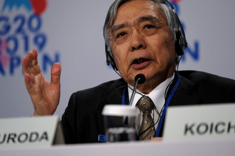 Bank of Japan Governor Haruhiko Kuroda takes questions from reporters at the annual meetings of