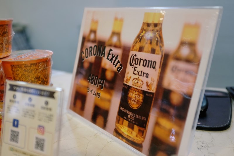 A sign advertising discounted Corona beers is displayed at the front desk of the Osaka Corona