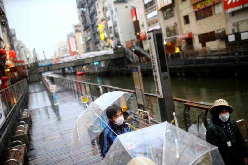 A vendor, wearing a protective mask following an outbreak of the coronavirus disease