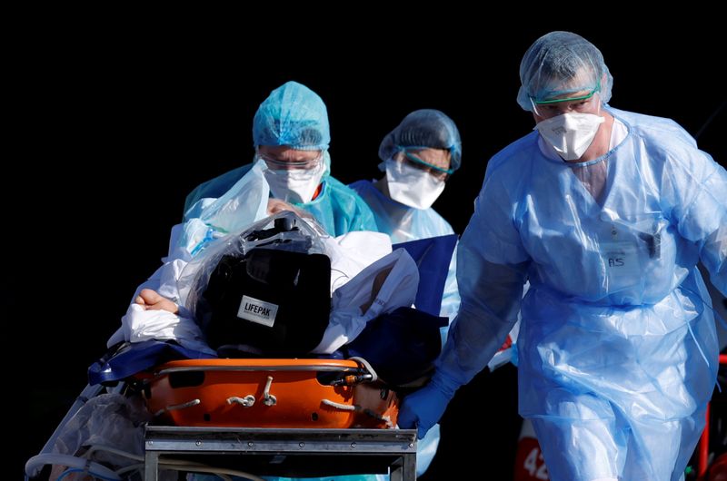 FILE PHOTO: Employees of the Vienna International Airport reload boxes with medical protective