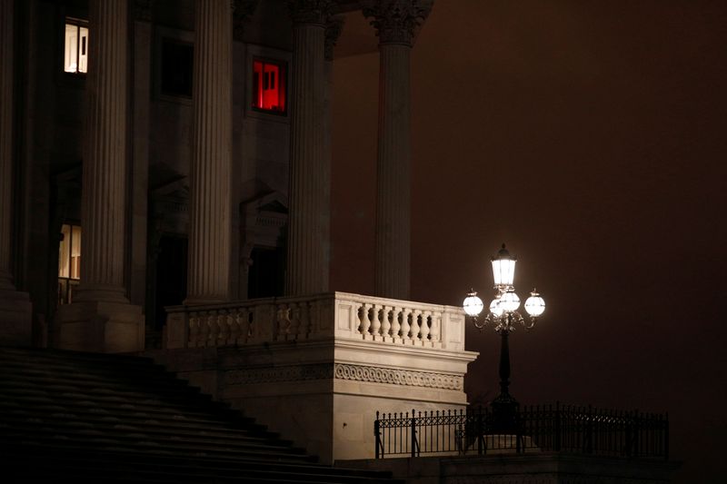 A window illuminated with a red light shines above the U.S. Senate steps, ahead of a vote on