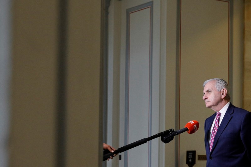 Senator Reed looks through a window between television news interviews, ahead of a vote on the