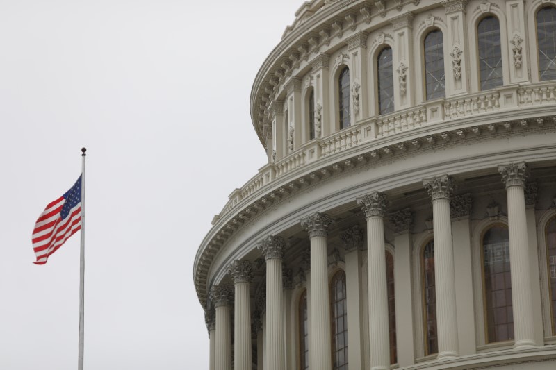 The U.S. Capitol during a morning rainstorm, after Congress agreed to a multi-trillion dollar