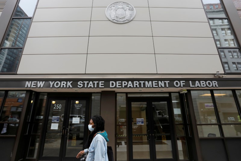 FILE PHOTO: A person walks by the entrance of the New York State Department of Labor offices,