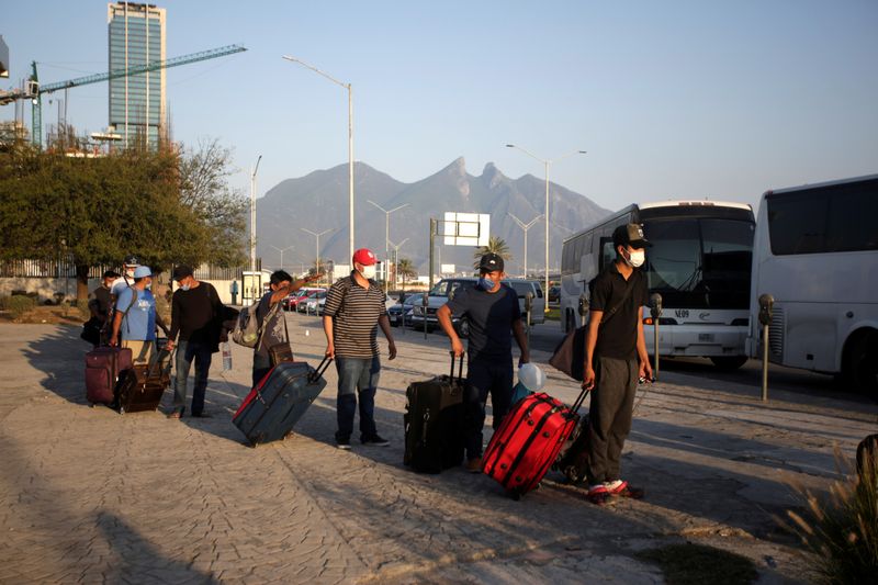 Migrants seeking for a U.S. work visa are seen waiting in a park of downtown of Monterrey