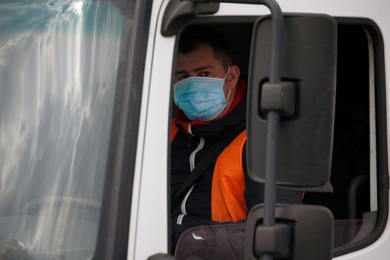 FILE PHOTO: A truck driver wearing a protective face mask arrives at the Amazon logistics