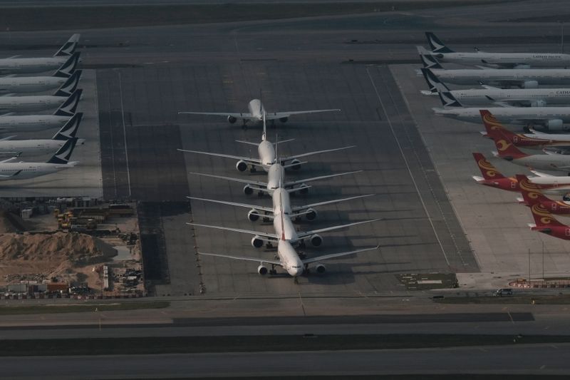 FILE PHOTO: Cathay Pacific aircraft are seen parked on the tarmac at the airport, following the