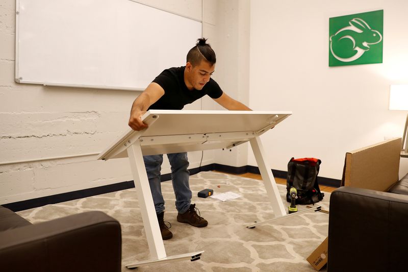 FILE PHOTO: TaskRabbit Tasker Guillermo Rodriguez assembles an IKEA table at the TaskRabbit