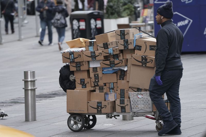 FILE PHOTO: An Amazon delivery person walks in Times Square following the outbreak of