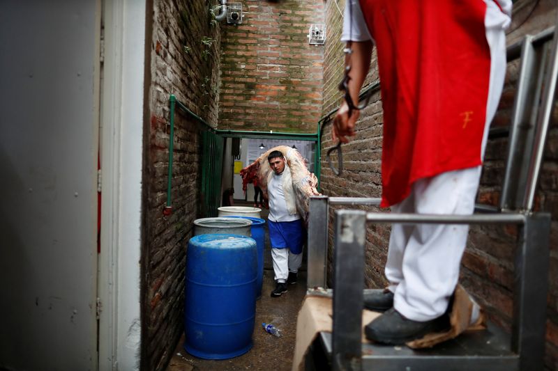 A butcher stores a cattle carcass in a butcher shop during the coronavirus disease (COVID-19),