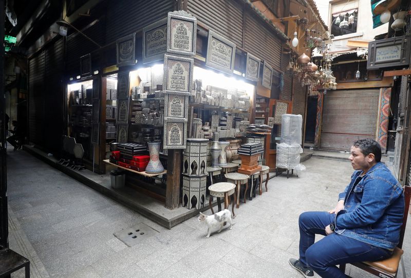 A shopkeeper waits for customers at a souvenir shop at a popular tourist area named 