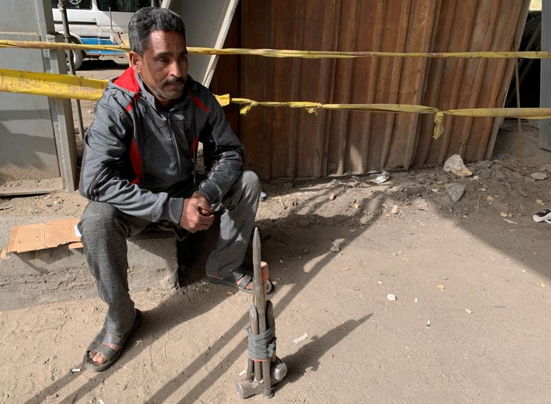 Laborer Yasser Nagi sits under a bridge and waits for work at the Saida Aisha district in Cairo