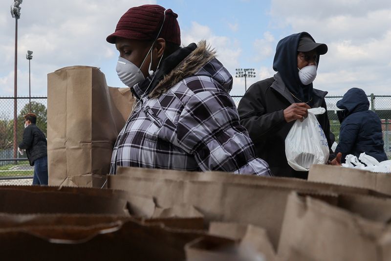 Volunteers distribute food to people in need during the coronavirus disease (COVID-19) outbreak