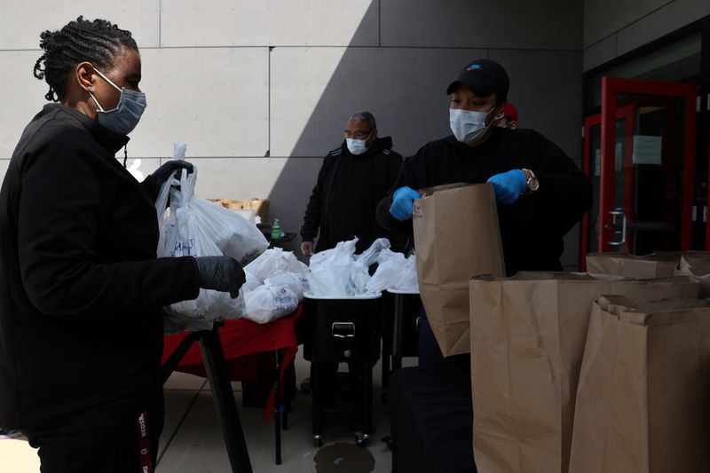 Volunteers distribute food to people in need during the coronavirus disease (COVID-19) outbreak
