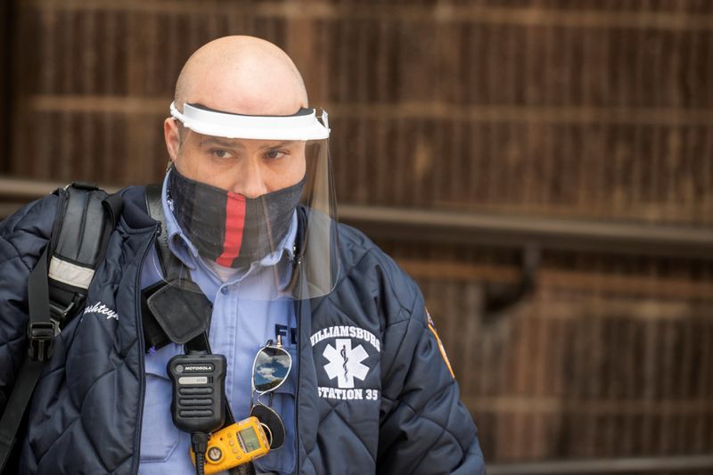 A UPS delivery driver wears a mask as he walks down the street during an ongoing outbreak of