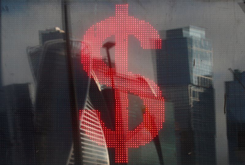 FILE PHOTO: The U.S. dollar sign is seen on a board at a currency exchange office in Moscow