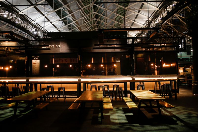 A couple walk through a deserted Covent Garden as venues close following growing number of